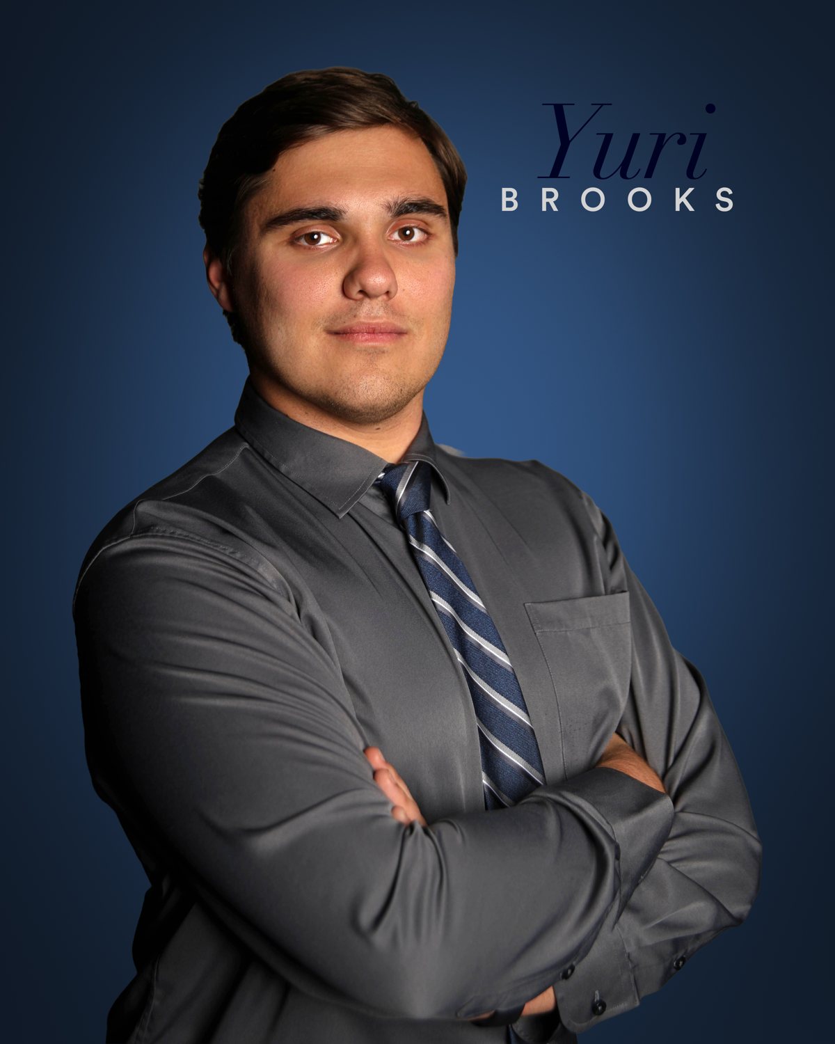 Professional branded headshot sample — gray shirt and tie on blue backdrop